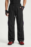 Waterproof Drawstring Trousers with Adjustable Hems in Black - front modeled view