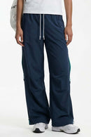 Waterproof Drawstring Trousers with Adjustable Hems in Navy Blue - front modeled view