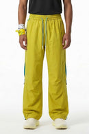 Waterproof Drawstring Trousers with Adjustable Hems in Yellow - front modeled view