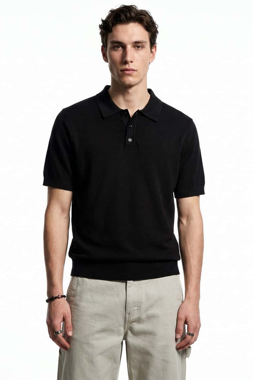 Relaxed Short-Sleeve Knit Polo Shirt in Black - full-length front modeled view