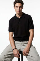 Relaxed Short-Sleeve Knit Polo Shirt in Black - full-length front modeled view