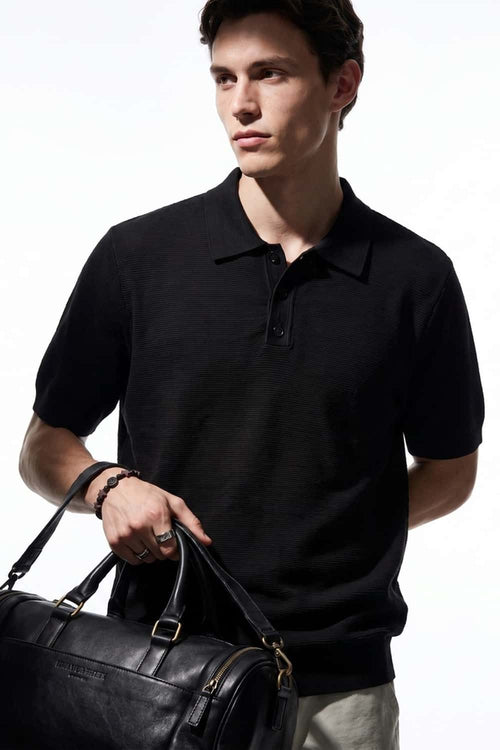 Relaxed Short-Sleeve Knit Polo Shirt in Black - full-length front modeled view