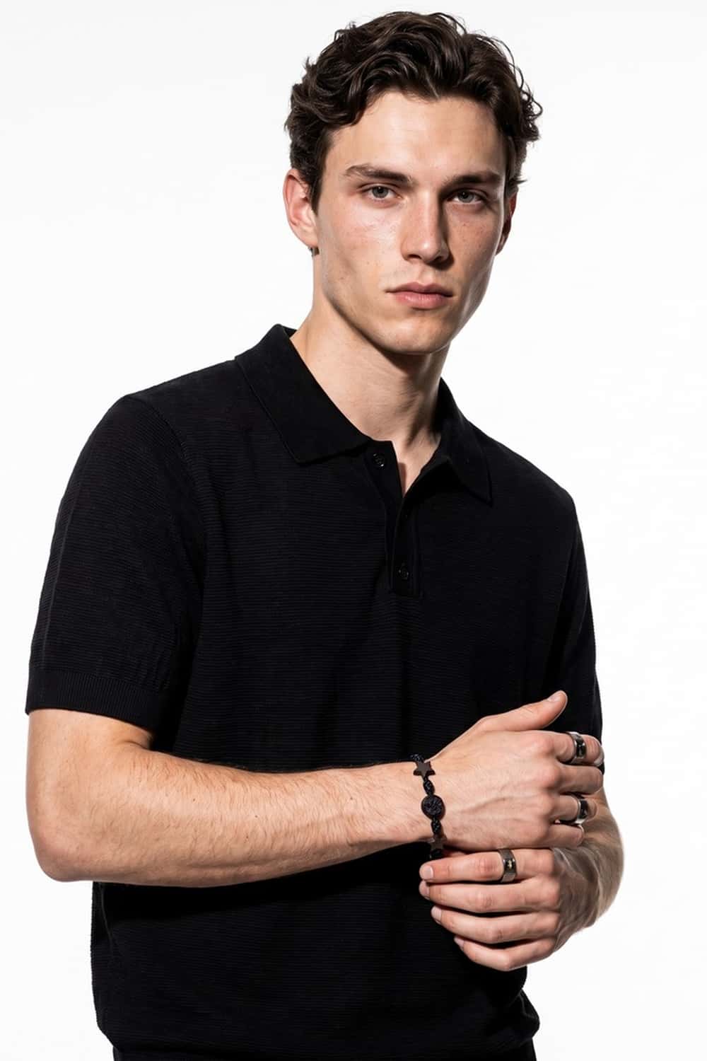 Relaxed Short-Sleeve Knit Polo Shirt in Black - front modeled close-up
