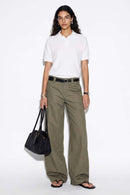 Relaxed Short-Sleeve Knit Polo Shirt in White - full-length front modeled view