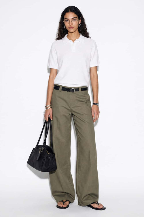 Relaxed Short-Sleeve Knit Polo Shirt in White - full-length front modeled view