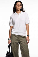 Relaxed Short-Sleeve Knit Polo Shirt in White - three-quarter front modeled view