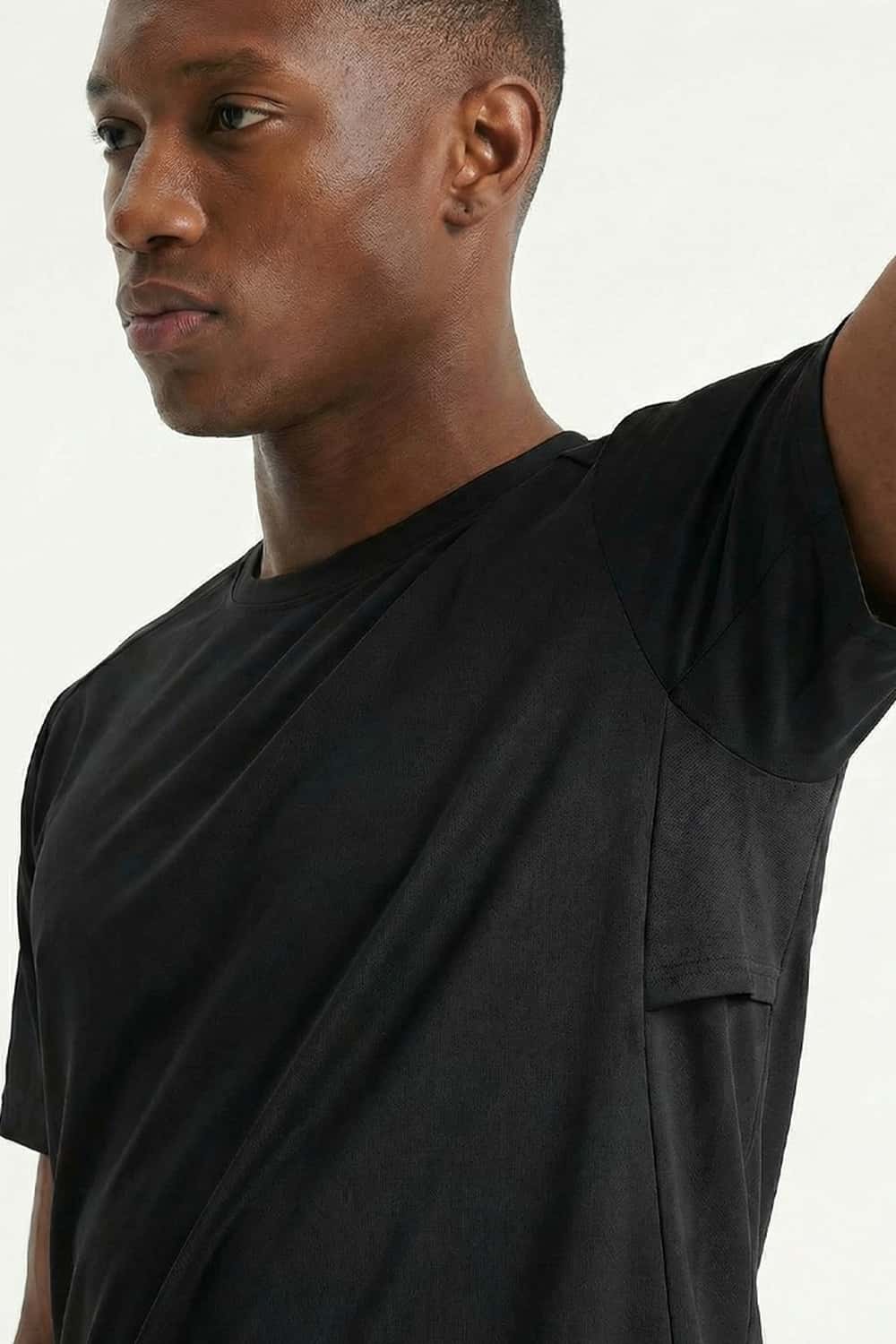 Moisture-Wicking Panelled Performance T-Shirt in Black - three-quarter front modeled view