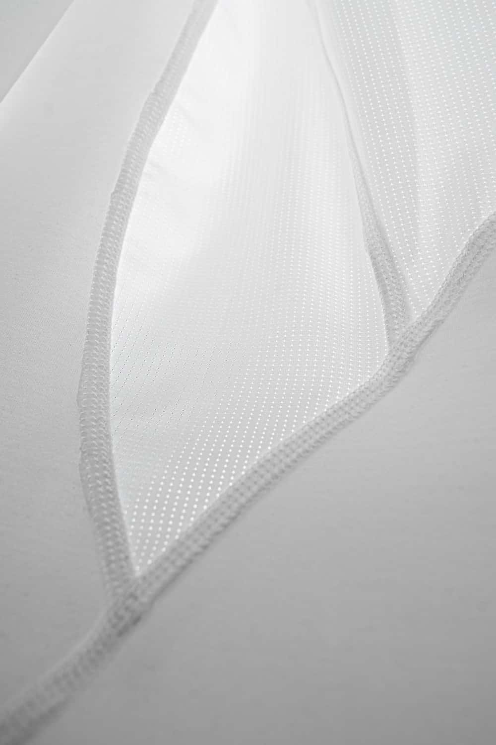 High-Stretch Panelled Training Tank in White - fabric texture close-up