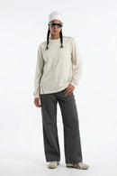 Exposed-Stitch Cotton Long-Sleeve Top in Apricot - full-length front modeled view