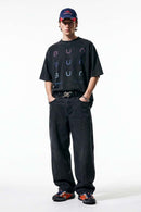 Curved-Leg Washed Cotton Pants in Black - full-length front modeled view