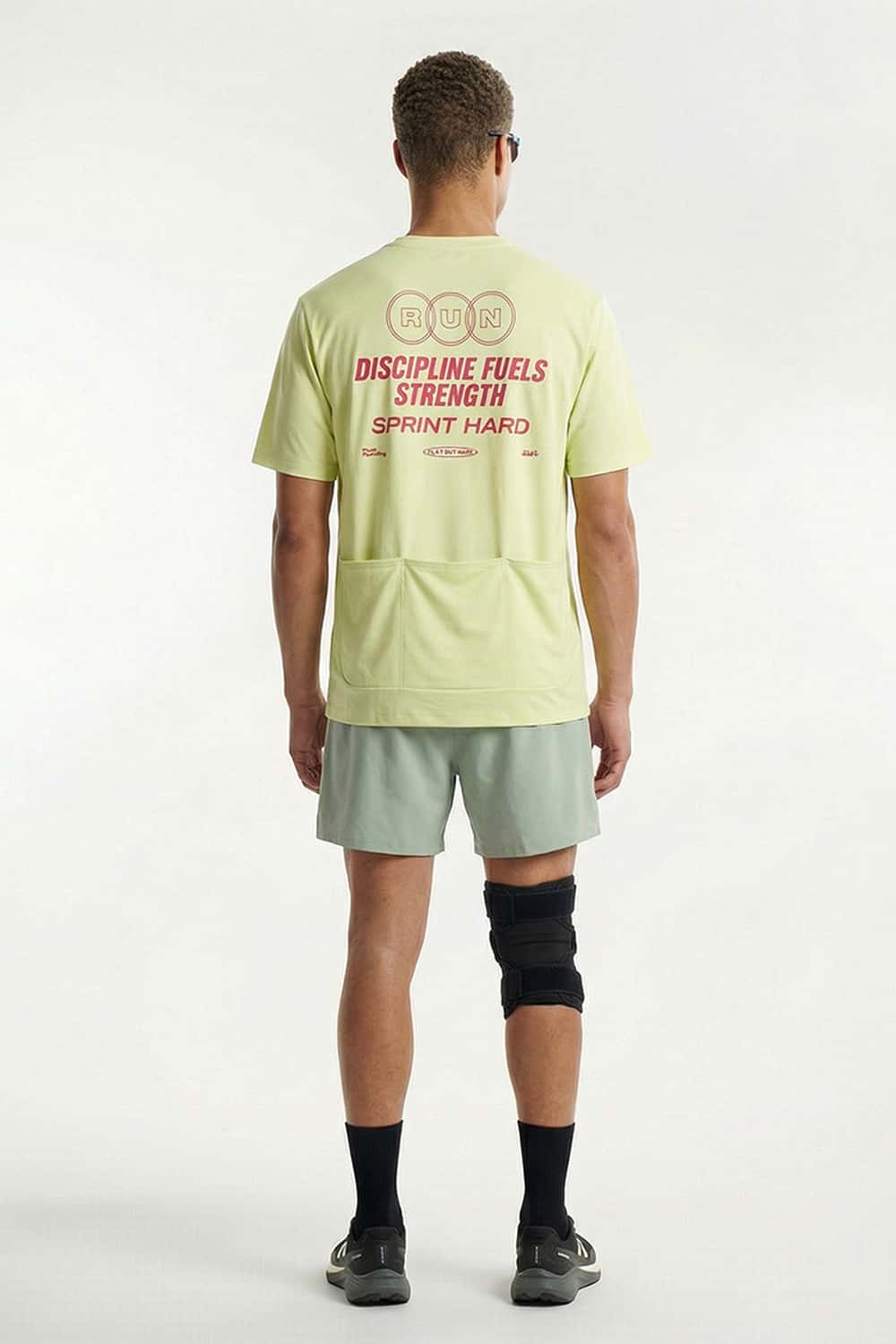 Trail-Running T-Shirt with Back Storage in Fluorescent Green - full-length back modeled view