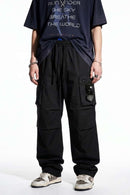 Drawstring Wide-Leg Cargo Trousers in Black - front modeled view