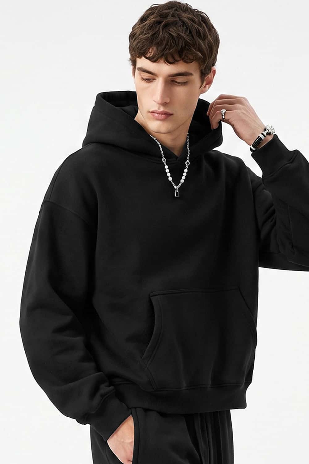 Fleece-Lined Boxy Pullover Hoodie in Black - three-quarter front modeled view