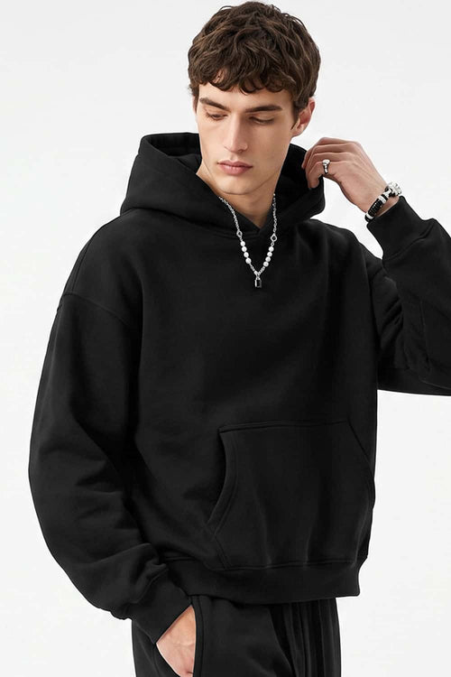 Fleece-Lined Boxy Pullover Hoodie in Black - three-quarter front modeled view