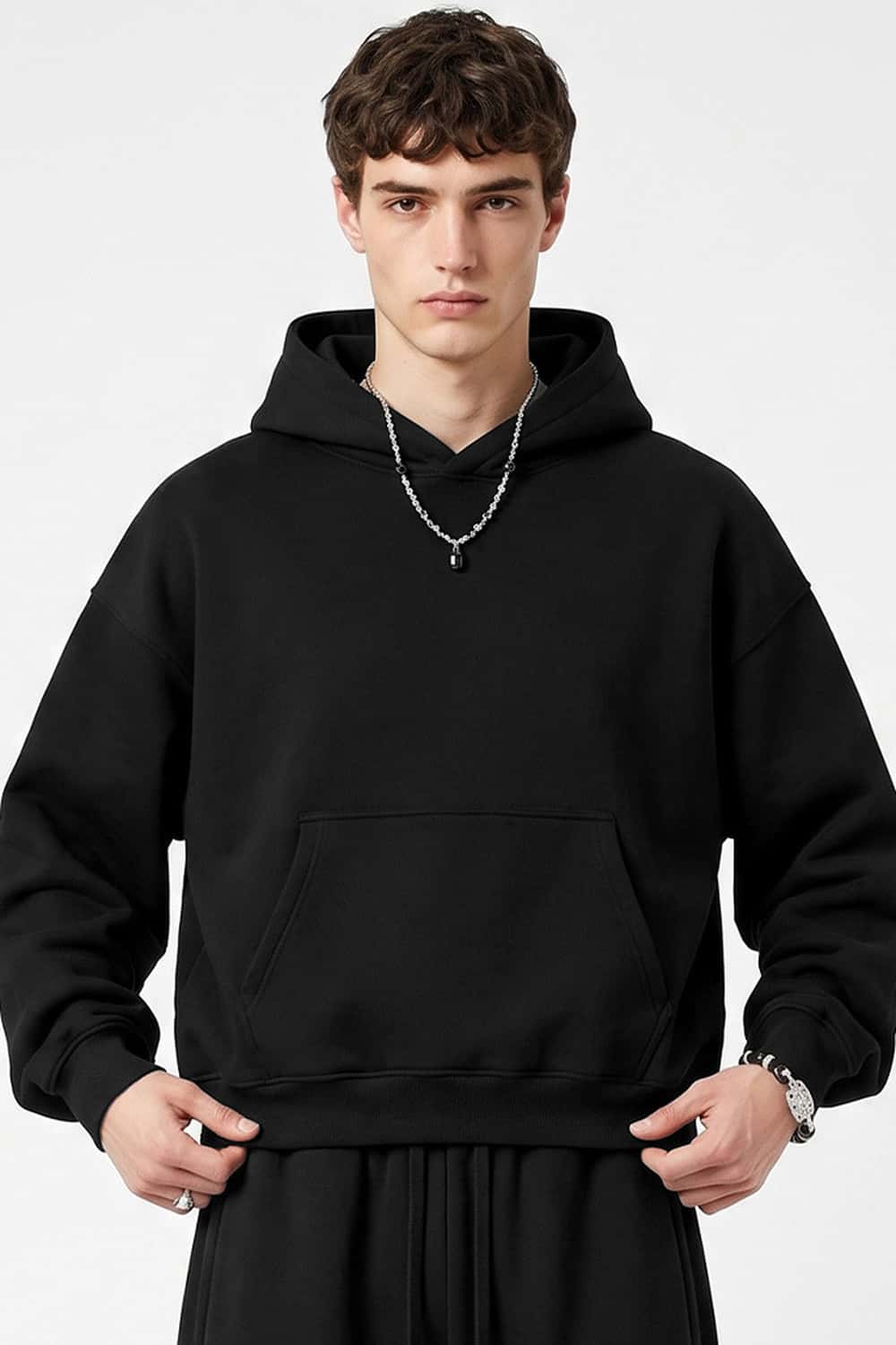 Fleece-Lined Boxy Pullover Hoodie in Black - front modeled view