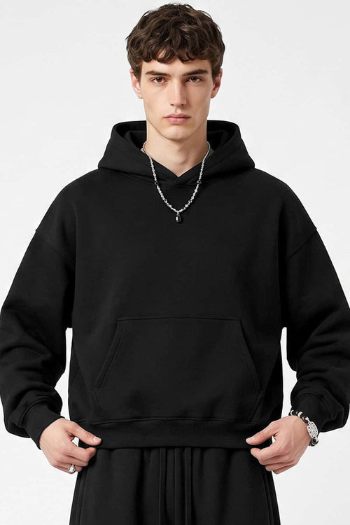 Fleece-Lined Boxy Pullover Hoodie in Black - front modeled view