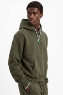 Fleece-Lined Boxy Pullover Hoodie in Military Green - three-quarter front modeled view