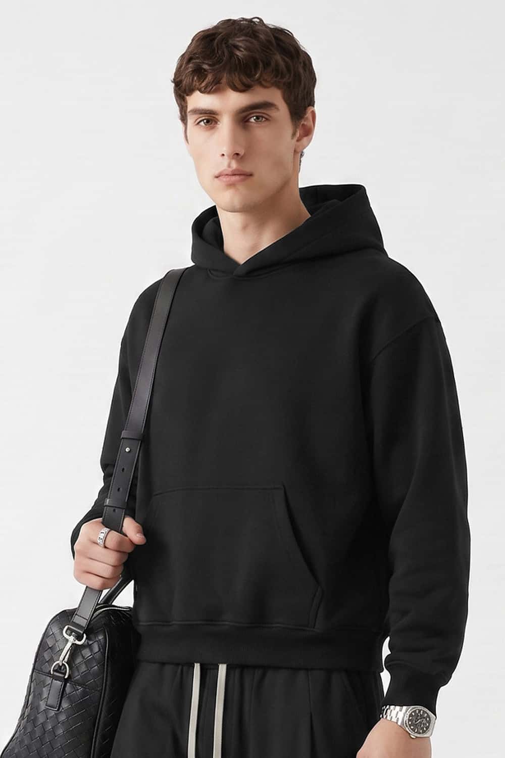 Relaxed Pullover Hoodie in Black - three-quarter front modeled view