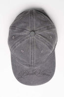 Six-Panel Cotton Baseball Cap with Cursive Artwork on the Brim in Light Gray - flat lay product view