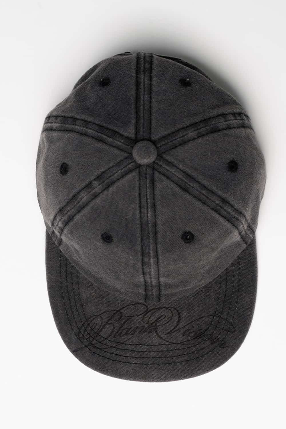 Six-Panel Cotton Baseball Cap with Cursive Artwork on the Brim in Vintage Black - flat lay product view