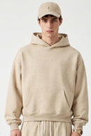 Relaxed Pullover Hoodie with Embroidered Emblem in Apricot - front modeled view