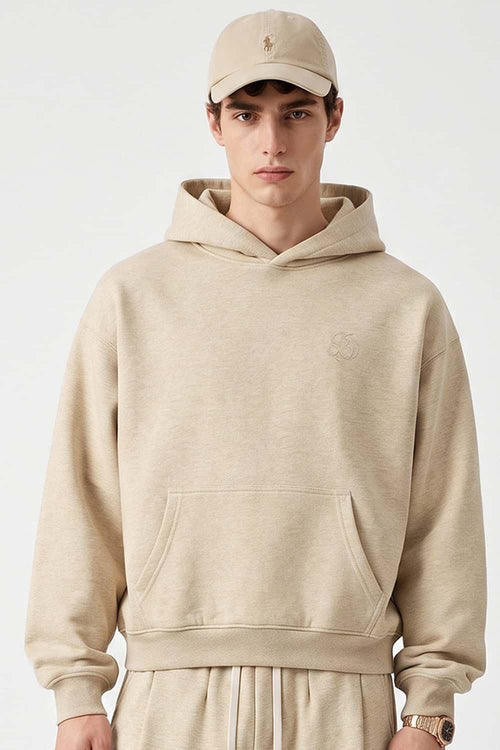Relaxed Pullover Hoodie with Embroidered Emblem in Apricot - front modeled view