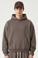 Relaxed Pullover Hoodie with Embroidered Emblem in Coffee - front modeled view