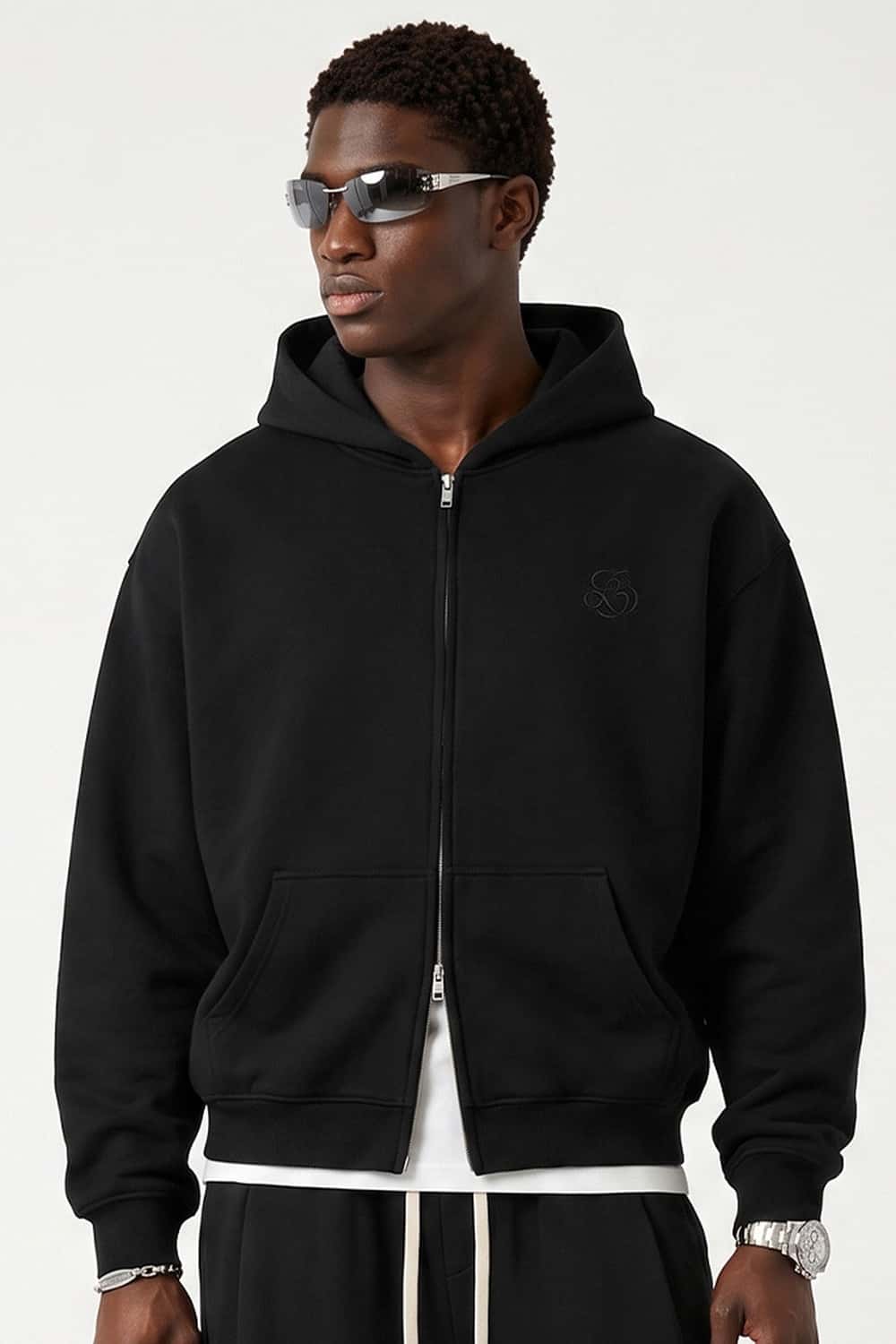Heavyweight Two-Way Zip Hoodie with Embroidered Emblem in Black - front modeled close-up