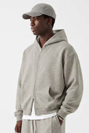 Heavyweight Two-Way Zip Hoodie with Embroidered Emblem in Oat Gray - three-quarter front modeled view